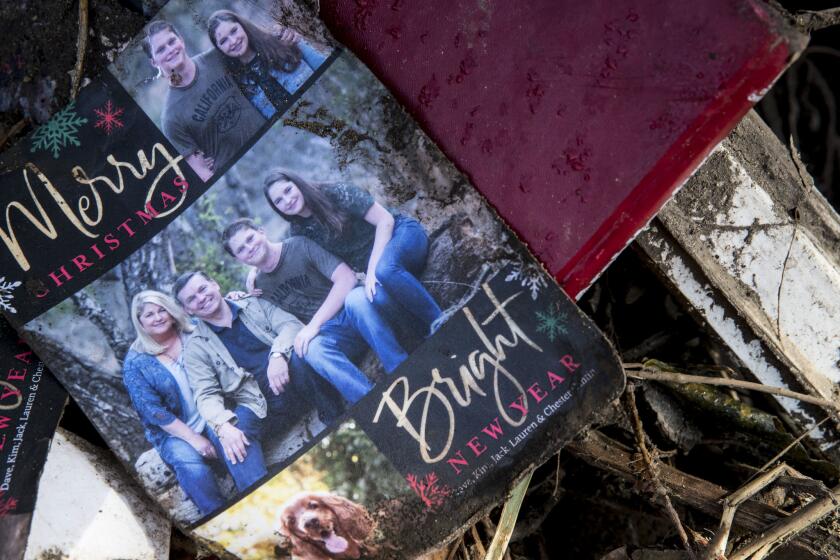 Cantin family holiday card in a pile of debris in the aftermath of mudslides. From left Kim, mother who survived, father David, who was killed, son Jack, who is still missing, and daugher Lauren who was pulled from the family home.