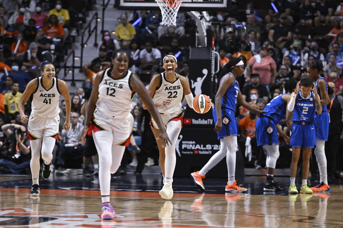 The Las Vegas Aces celebrate their WNBA title win over the Connecticut Sun on Sunday.