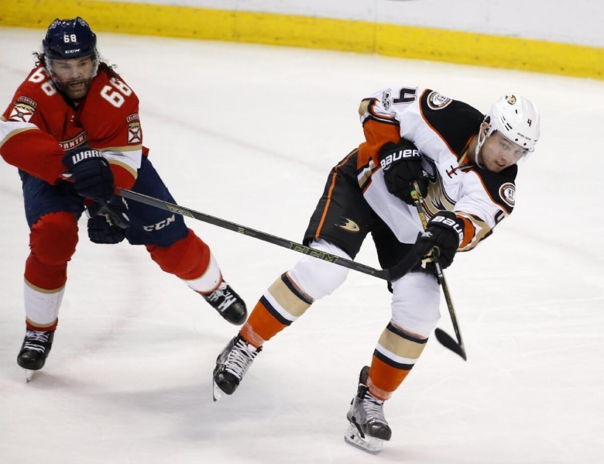 Ducks defenseman Cam Fowler (4) passes the puck as he is pursued by Panthers right wing Jaromir Jagr (68) during the second period on Feb. 3.
