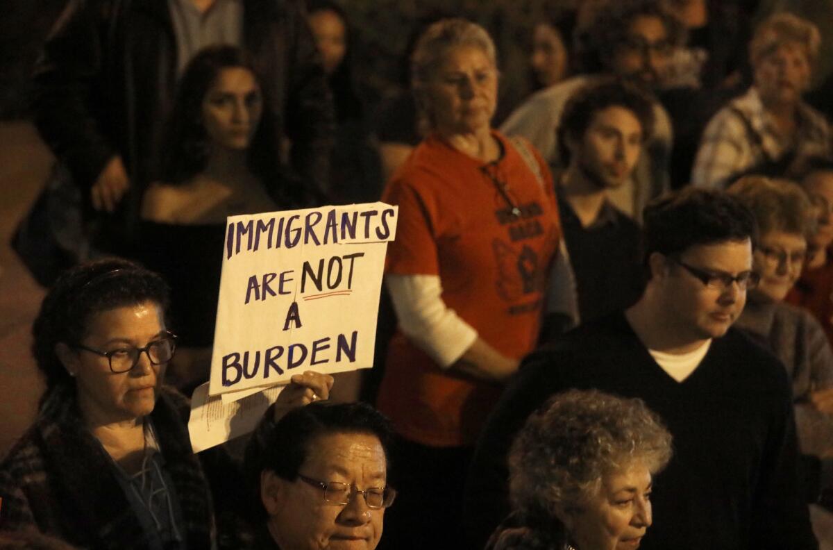 Tonya Rios, left, joins other advocacy groups in front of City Hall in San Gabriel to express concerns about the San Gabriel Police Department's working with a subdivision of Immigration and Customs Enforcement.