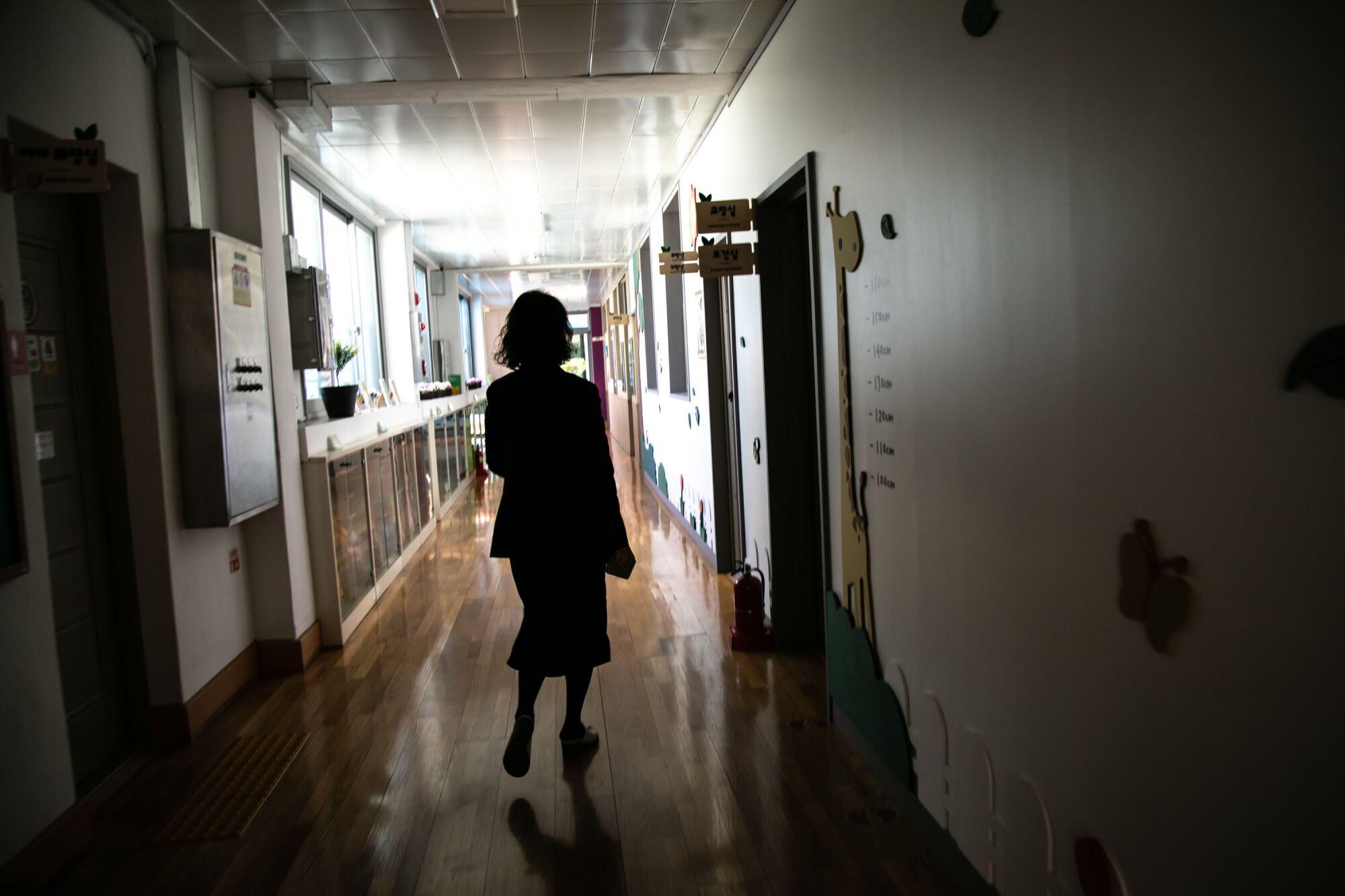 The principal walks in a hallway at Dochang Elementary.