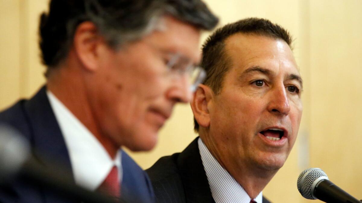 Joseph Otting, right, then chief executive of OneWest Bank, speaks at a 2015 hearing in Los Angeles, regarding the bank's purchase by CIT Group.