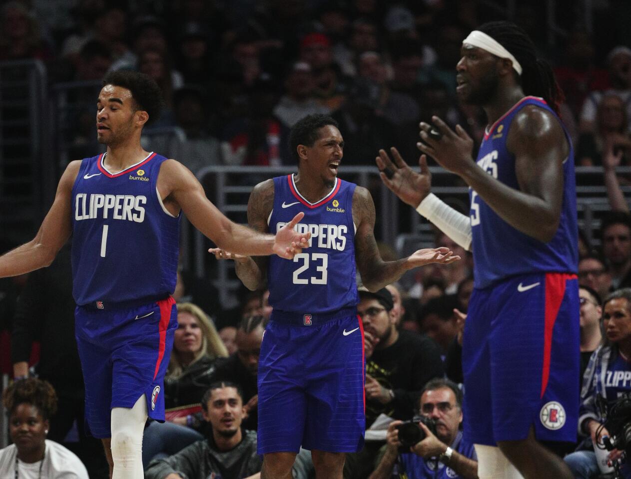 Clippers teammates Lou Williams, Jerome Robinson and Montrezl Harrell react to a call.