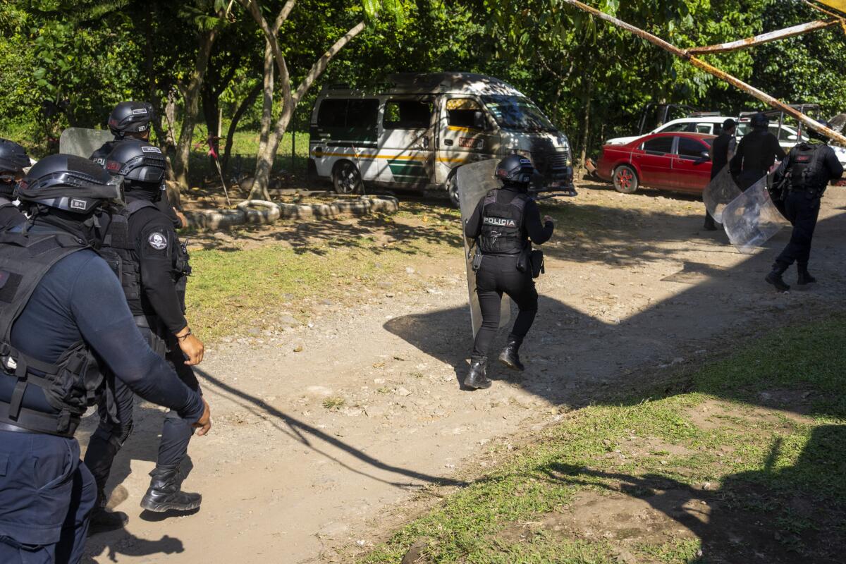 Police in riot gear charge during a training exercise