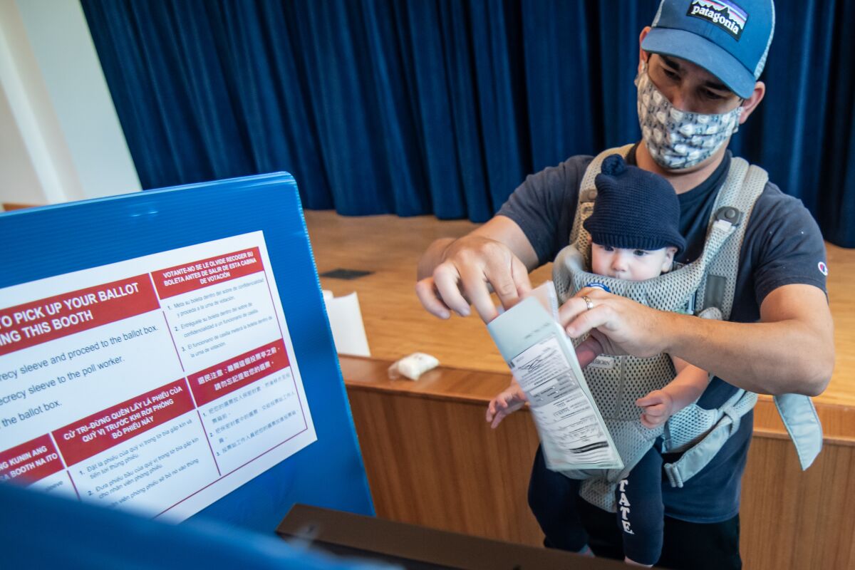 Ken Dugan wears a mask while voting at the San Marcos Civic Center 