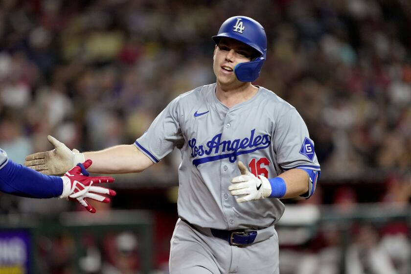 Los Angeles Dodgers' Will Smith crosses the plate after hitting a solo home run during the sixth inning of a baseball game against the Arizona Diamondbacks, Monday, April 29, 2024, in Phoenix. (AP Photo/Matt York)