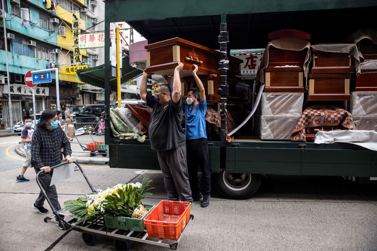 Empty coffins are delivered to funeral businesses in the Kowloon district of Hong Kong.