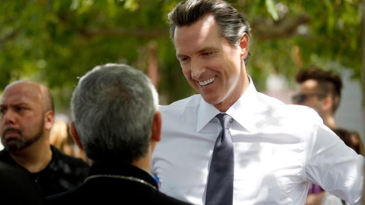 Lt. Gov. Gavin Newsom speaks with participants of a march in Pan Pacific Park in Los Angeles commemorating the 102nd anniversary of the Armenian genocide in April.