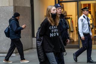 Hunter Schafer is taken into custody during a cease-fire demonstration