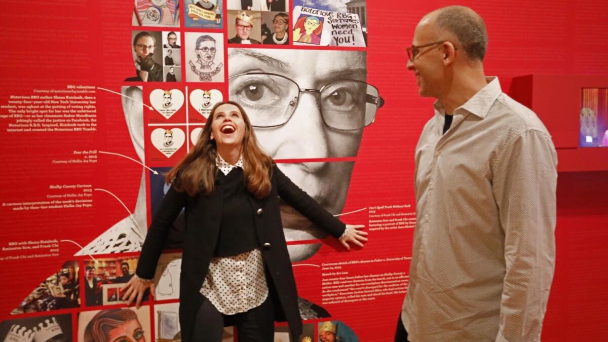 Jones and screenwriter Daniel Stiepleman, nephew of Justice Ruth Bader Ginsburg, spend a light moment together at the exhibit.