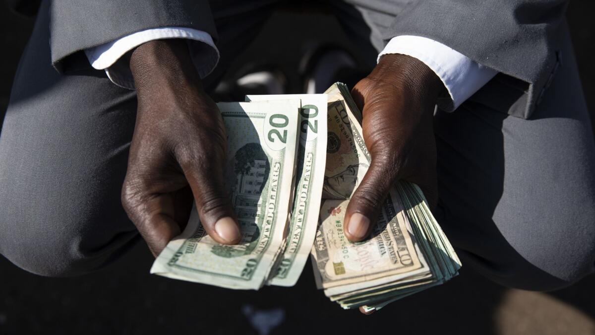 The long-running cash shortage is one of the most visible symptoms of Zimbabwe's wrecked economy.