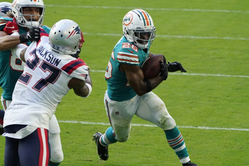 Miami Dolphins running back Salvon Ahmed (26) runs for a two-point conversion.