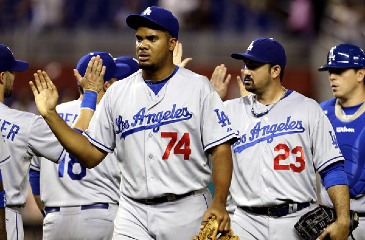 Dodgers closer Kenley Jansen, center, celebrates with teammates after a victory over the Miami Marlins last month.