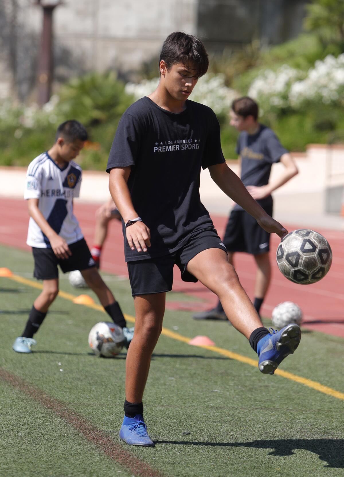Camper Matthew Murillo, 13, of San Gabriel, juggles the ball in a 1-minute juggling contest that he scored 86 juggles at the St. Francis Summer Soccer Camp led by St. Francis Coach Glen Appels at St. Francis High School on Monday, July 29, 2019. The camp encourages boys and girls from six to eighteen to learn soccer skills in shooting, dribbling, passing, and ball control through drills and video.