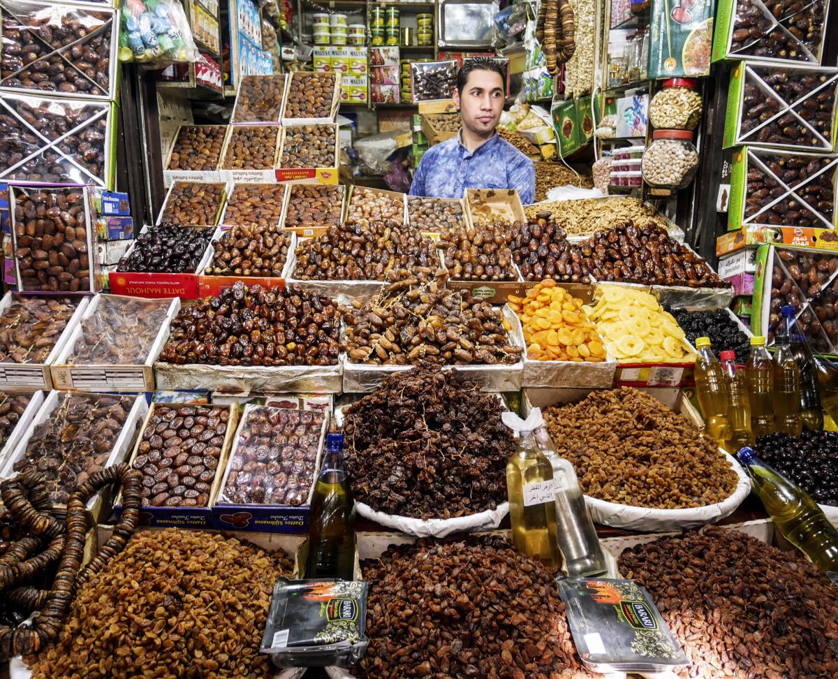 A man hawks dates and other dried fruits in one of the thousands of stalls in the souks of the ancient walled city in Fez.