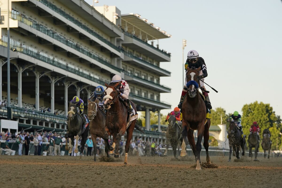 Jockey John Velazquez riding Authentic, right, crosses the finish line to win the 146th running of the Kentucky Derby at Churchill Downs, Saturday, Sept. 5, 2020, in Louisville, Ky. (AP Photo/Jeff Roberson)