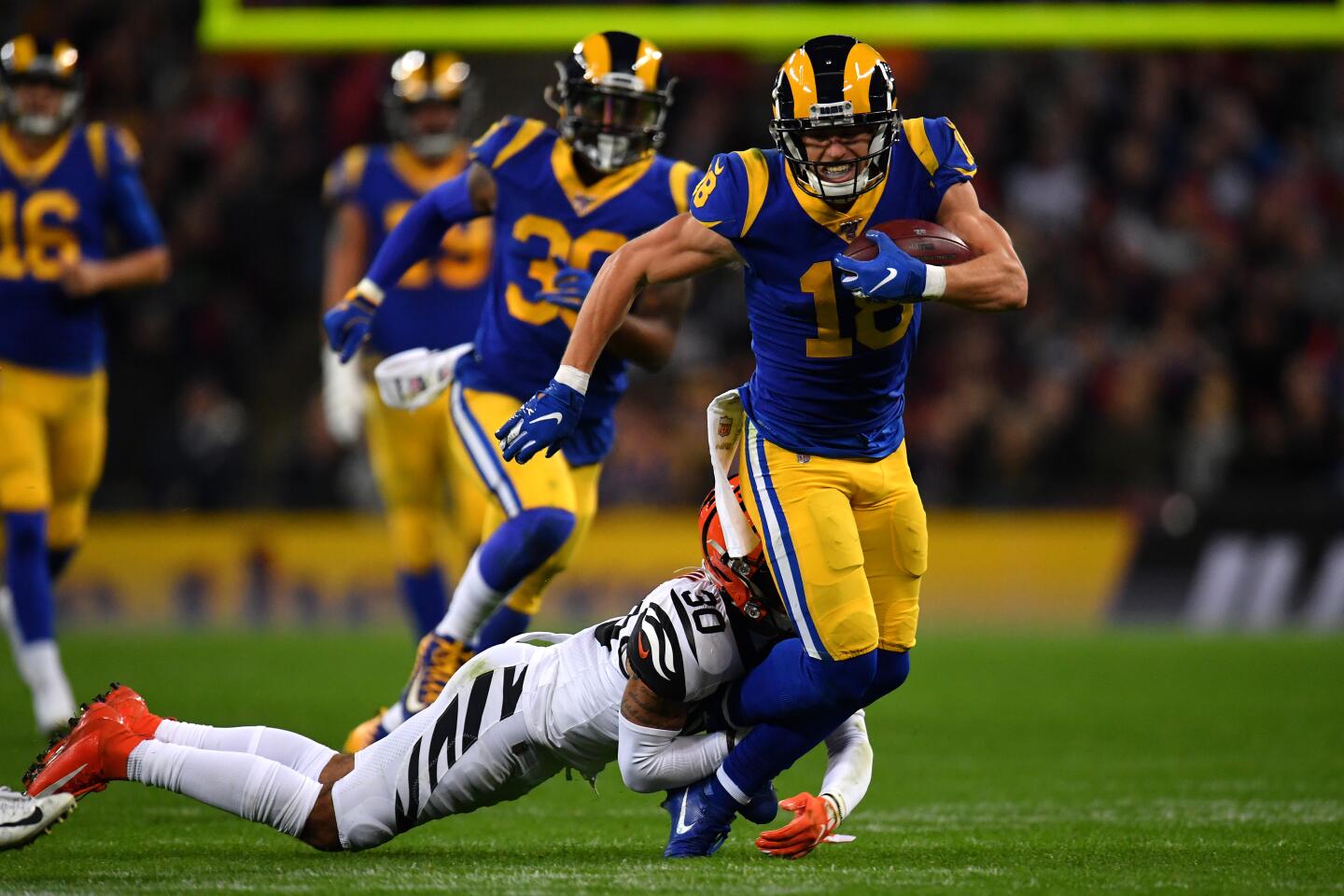 Rams receiver Cooper Kupp is tackled by Bengals defensive back Jessie Bates.