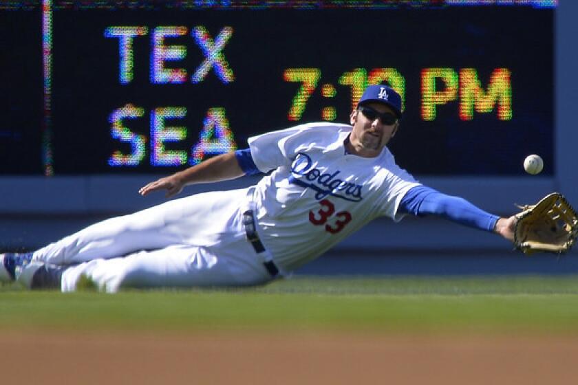 Dodgers left fielder Scott Van Slyke tries to make a catch on a sinking live drive by Cardinals catcher Yadier Molina that went for a run-scoring double in the first inning Saturday.