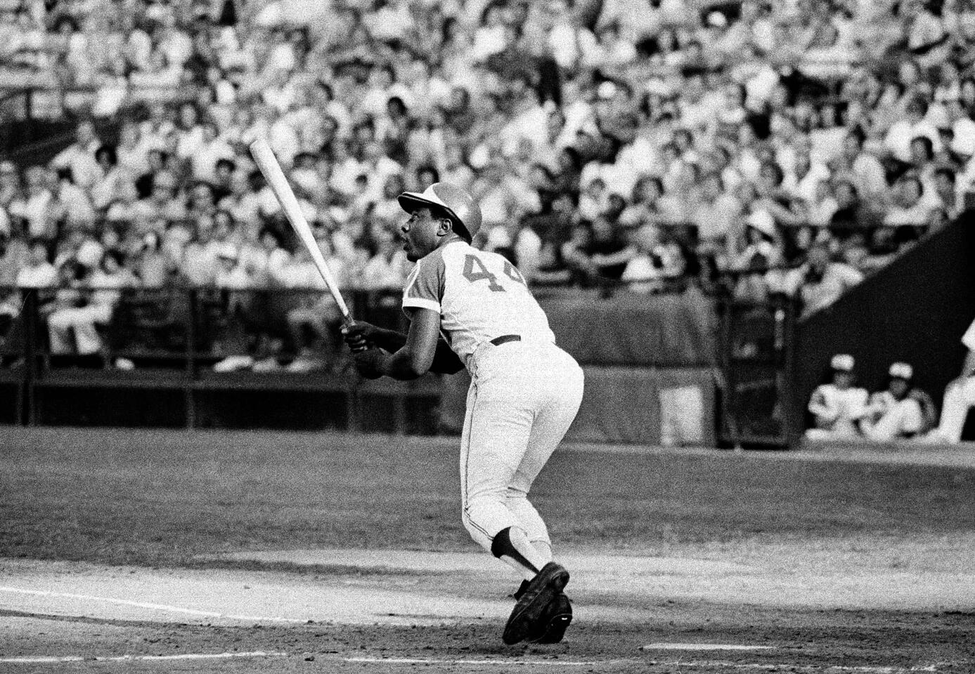 Atlanta Braves' Hank Aaron watches the flight of the ball as he hits his 700th career home run