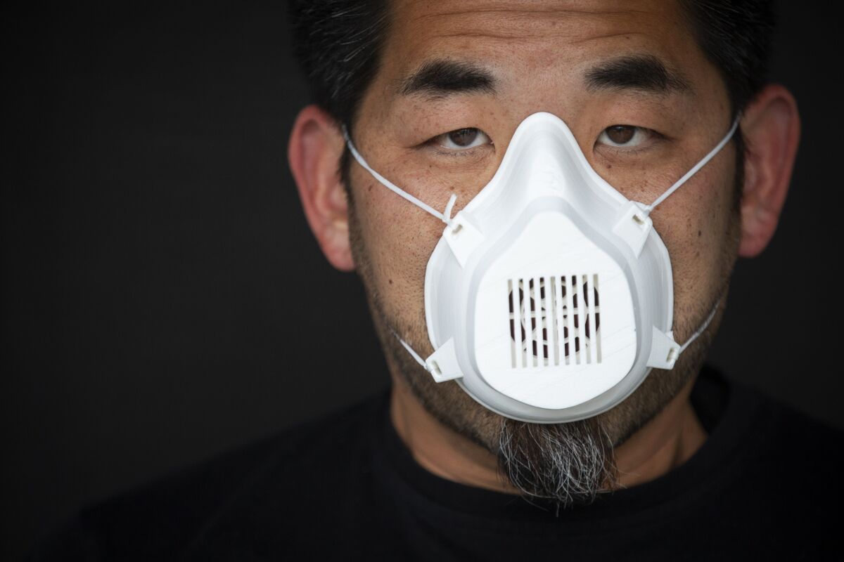 Alvin Huang wears one of his "pseudo N95 masks," which he 3-D printed for healthcare workers during the coronavirus crisis.
