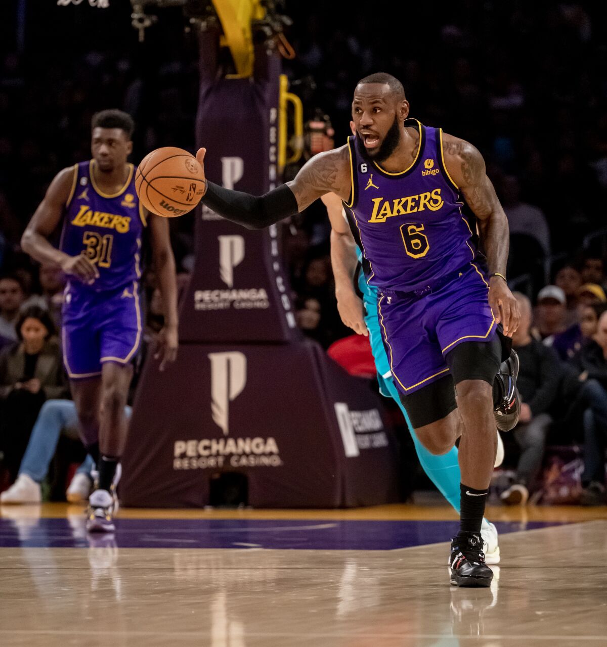 El alero de los Lakers, LeBron James, dirige a sus compañeros contra los Hornets en la primera mitad.