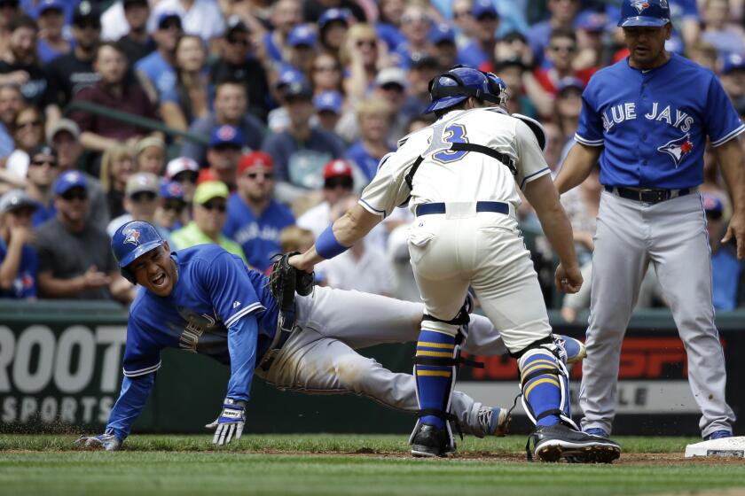 Mariners catcher Mike Zunino tags out Toronto's Ezequiel Carrera, left, out at third base to finish a triple play Sunday in Seattle.