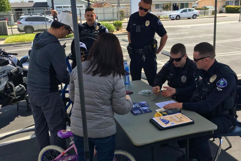 Costa Mesa police officers at a bicycle safety event Saturday encourage locals to register their bikes through Project 529.