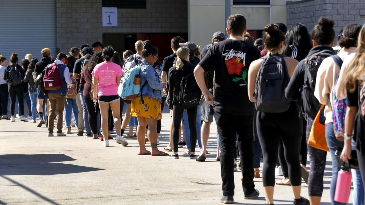 Students stand in line on Oct. 8 at Viejas Arena on SDSU campus to receive type B meningococcal disease vaccinations after three cases appeared among university undergraduates.