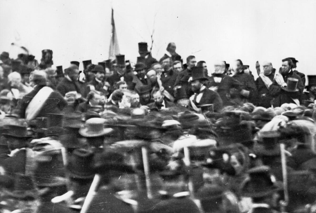 President Abraham Lincoln, bareheaded and bearded in the center, in a stereopticon image taken at the Nov. 19, 1863, dedication of a national cemetery on the site of the battle of Gettysburg in July.