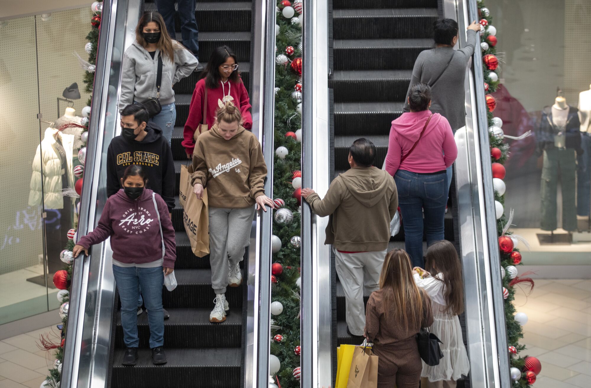 Black Friday shoppers ride the escalator at the Glendale Galleria.