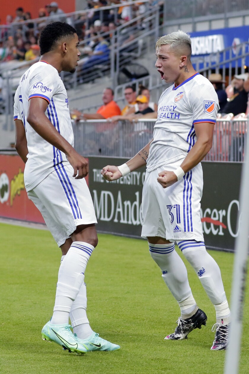 FC Cincinnati's Brenner, left, and Alvaro Barreal (31) celebrate Barreal's goal during the first half of the team's MLS soccer match against the Houston Dynamo on Saturday, July 3, 2021, in Houston. (AP Photo/Michael Wyke)