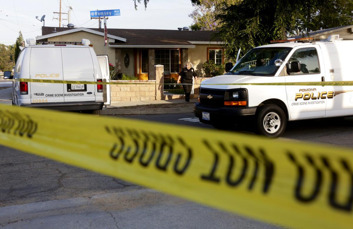 Police tape surrounds the scene at a home in the 2100 block of Ramsey Way in Pomona where four bodies when discovered.