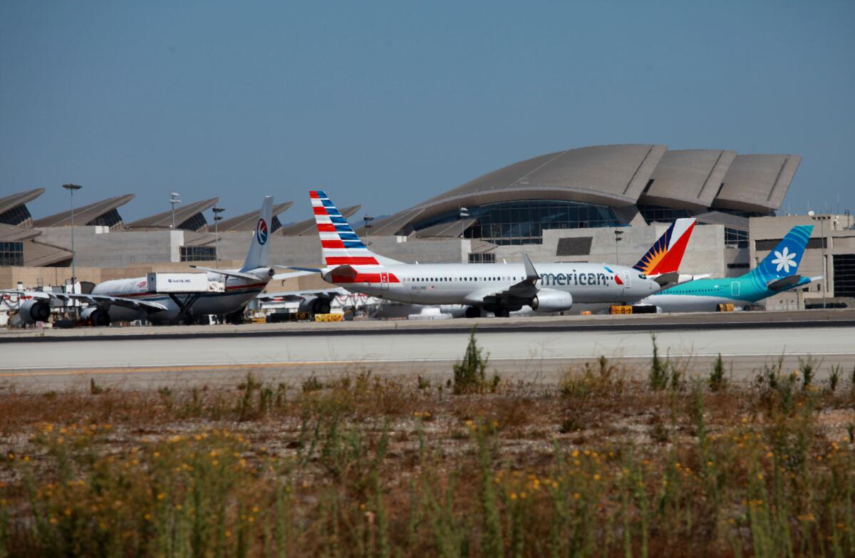 Taxiing aircraft pass near the Tom Bradley International Terminal at Los Angeles International Airport. Plans call for a new midfield concourse west of the Bradley.