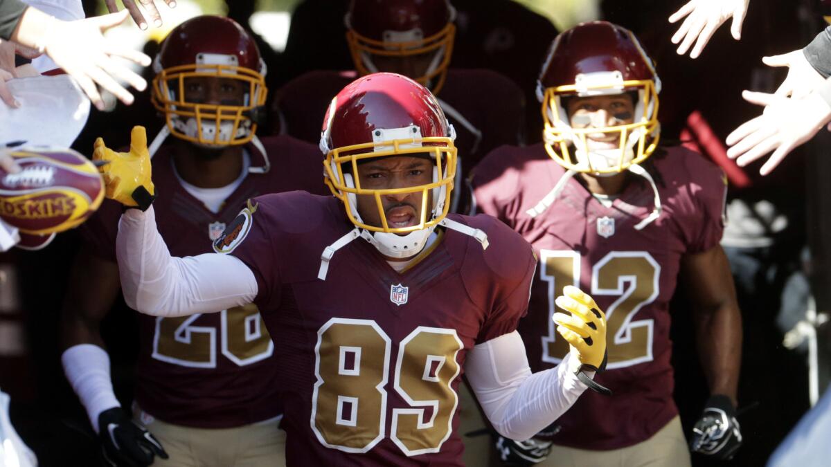 Washington Redskins wide receiver Santana Moss, center, leads his teammates onto the field before a game against the Tennessee Titans last month.
