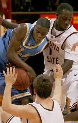 Arizona State guard Antwi Atuahene, right, battles for the ball with UCLA guard Darren Collison, left, as Arizona State's Derek Glasser, foreground, reaches for the ball.