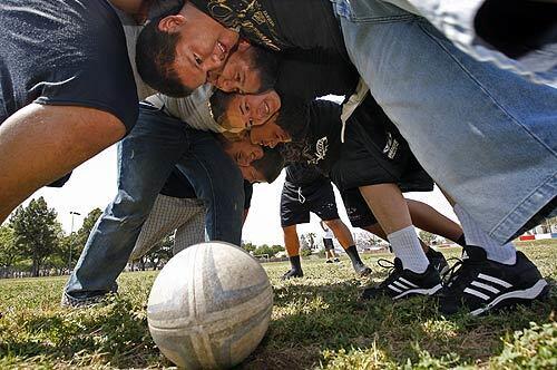 An Eagles rugby team from Hawaiian Gardens lines up in a scrum to start the action. Coach Ernie Vargas has his two boys and one girls teams going to state playoffs this weekend.