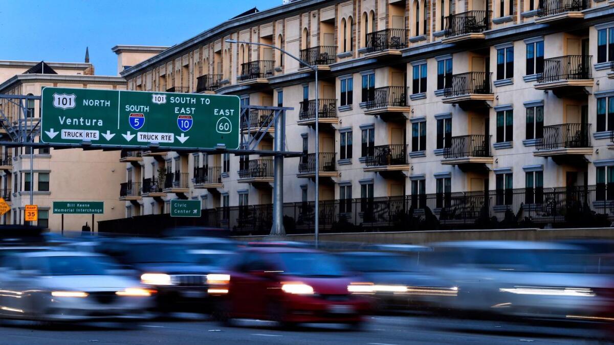 Motorists make their way along the 110 Freeway in downtown Los Angeles past the Da Vinci Apartments.