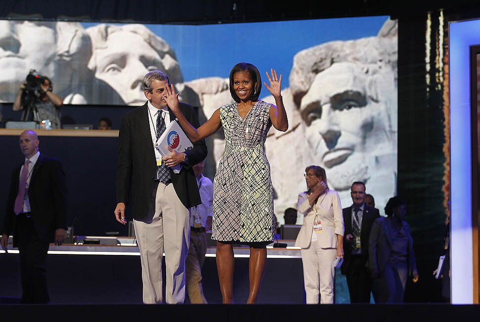 First Lady Michelle Obama waves as she arrives for a sound check at the Time Warner Cable Arena.