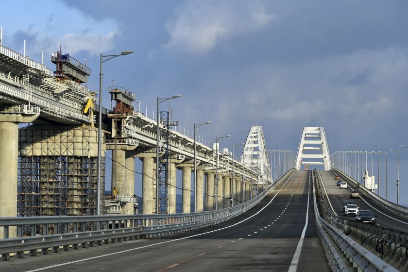 FILE - First cars and other vehicles drive on the Crimean Bridge connecting Russian mainland and Crimean peninsula over the Kerch Strait after restoration works, not far from Kerch, Crimea on in Kerch, Crimea, Thursday, Feb. 23, 2023. A top Ukrainian official on Sunday, April 2, 2023, outlined a series of steps the government in Kyiv would take after the country reclaims control of Crimea, including dismantling the strategic bridge that links the seized Black Sea peninsula to Russia. (Rosavtodor Press Service via AP, File)