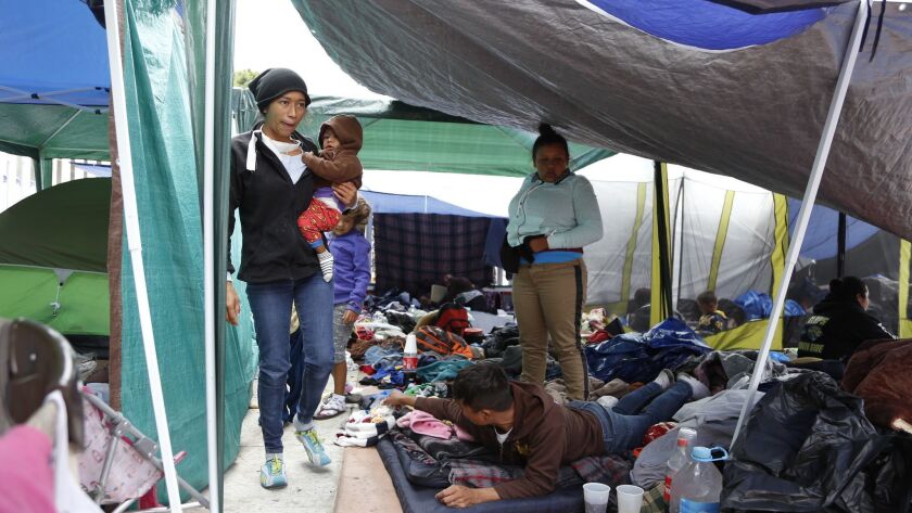 Central American asylum seekers in Tijuana sleep underneath the tarps and shades provided for them by donations.