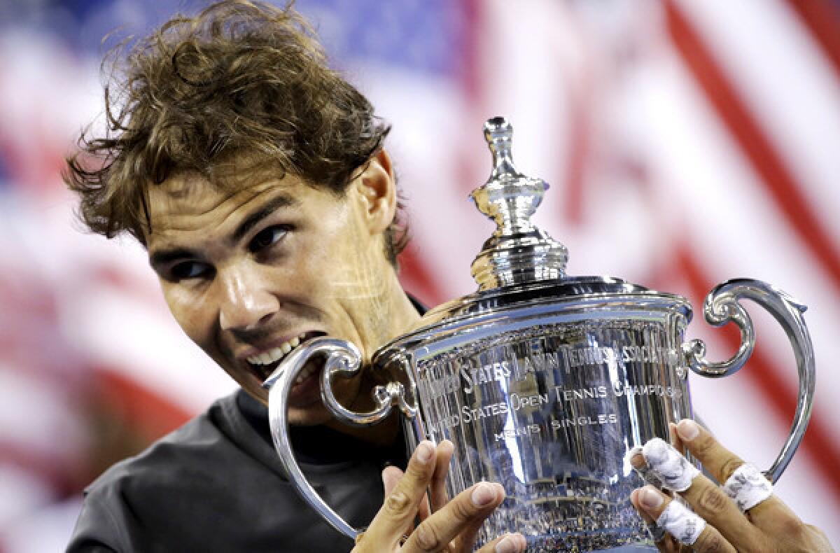 Rafael Nadal gives the winner's trophy a bite after defeating Novak Djokovic in the men's singles final at the U.S. Open on Monday night in New York.