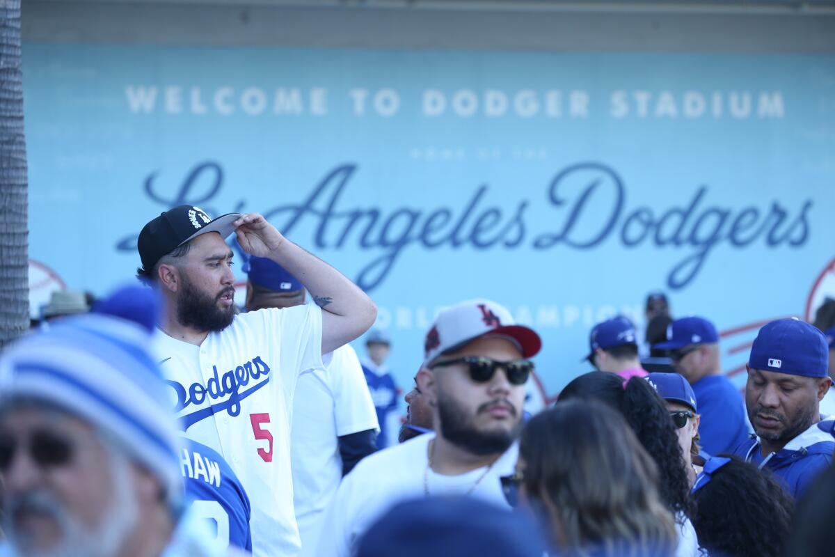 Dodgers fans walk through the stadium during the team's home opener against the Cincinnati Reds in April.
