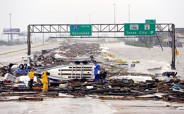 Battered boats and other debris, washed up by Hurricane Ike's storm surge, block Interstate 45 in Galveston, Texas.