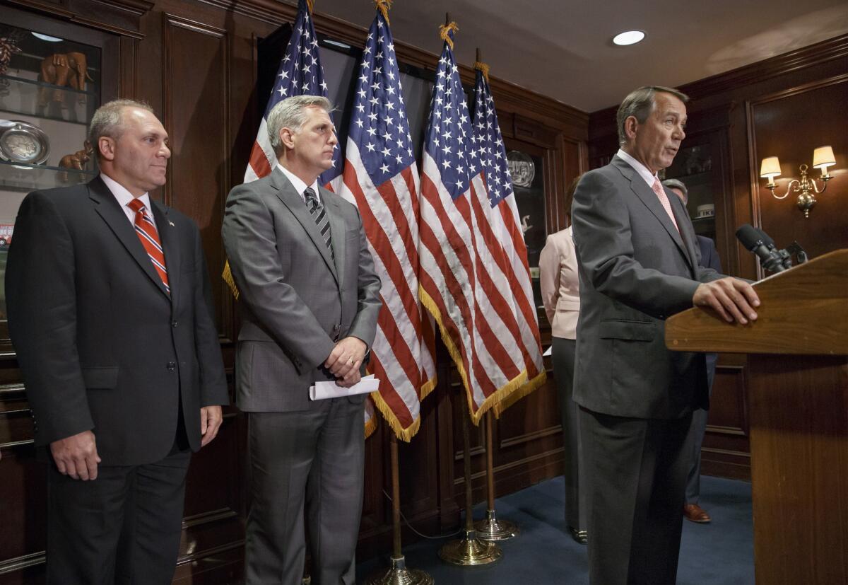 House Speaker John Boehner of Ohio, right, accompanied by incoming House Majority Whip Steve Scalise of Louisiana, left, and incoming House Majority Leader Kevin McCarthy of Bakersfield, speaks to reporters on Capitol Hill on Tuesday.