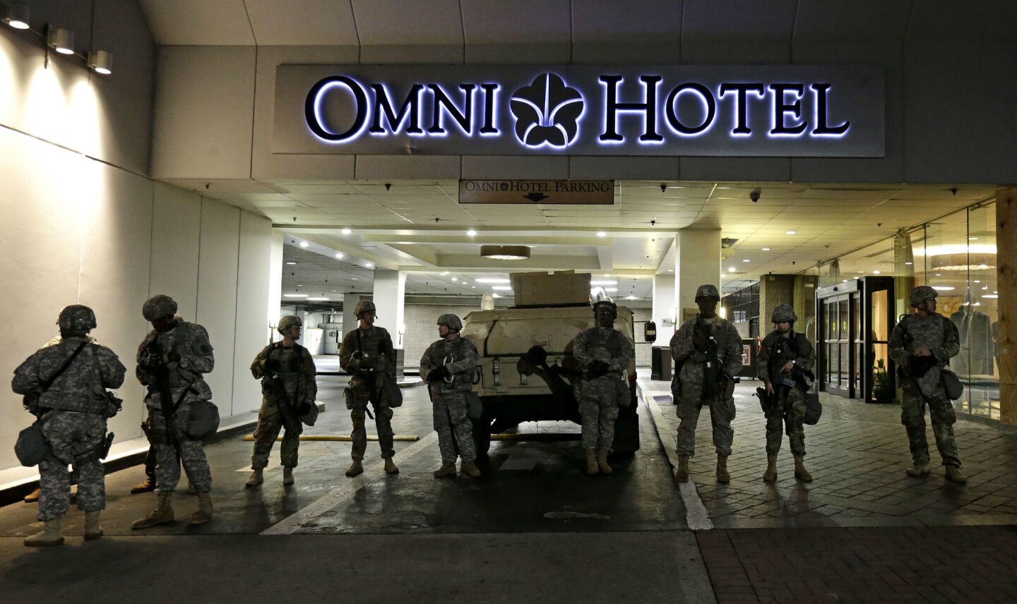 Members of the North Carolina National Guard stand guard outside the Omni Hotel in downtown Charlotte on Thursday.