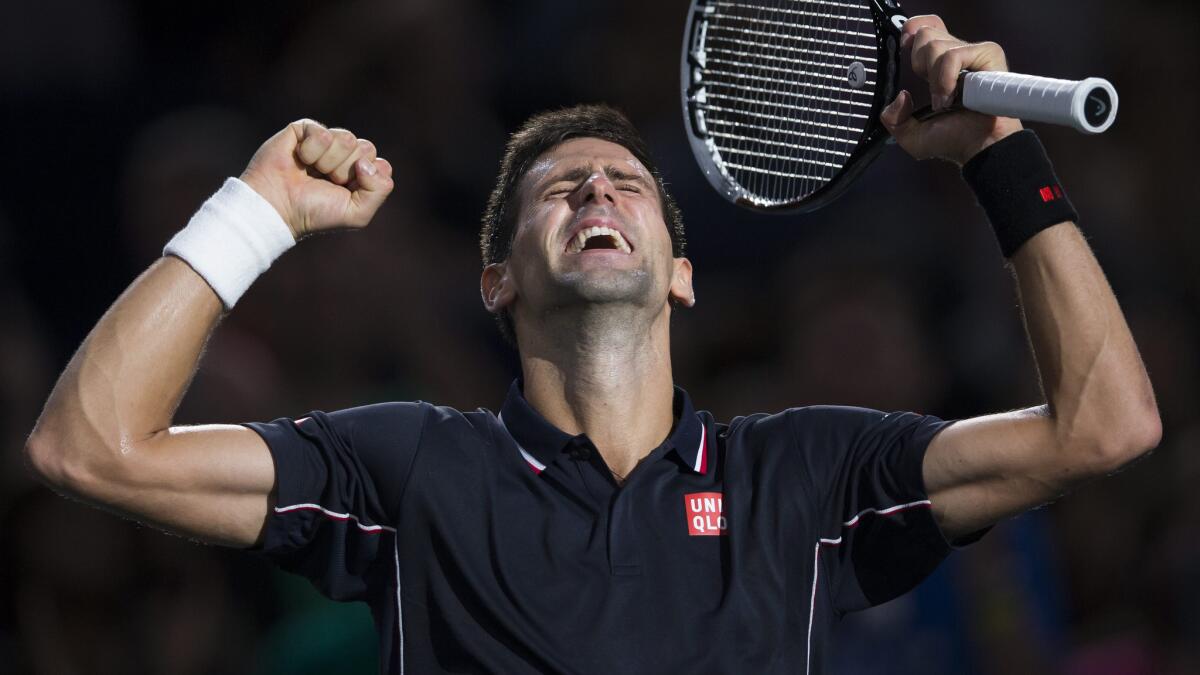 Novak Djokovic celebrates after defeating Milos Raonic at the Paris Masters on Sunday.