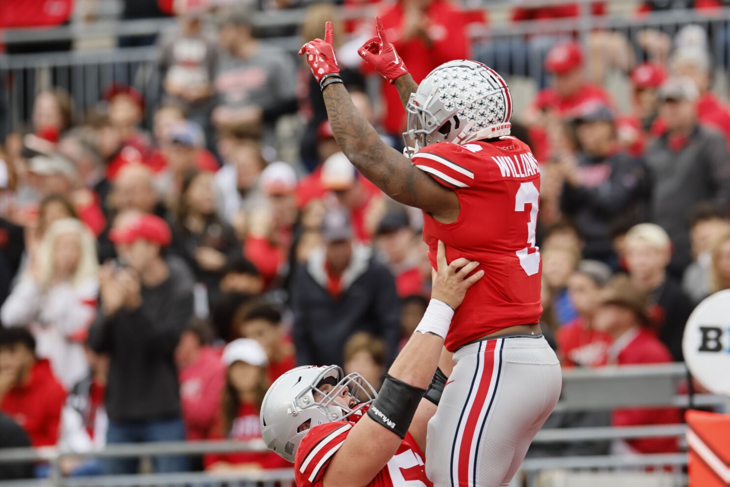 Ohio State running back Miyan Williams, top, celebrates his touchdown against Rutgers with teammate offensive lineman Matthew Jones during the first half of an NCAA college football game, Saturday, Oct. 1, 2022, in Columbus, Ohio. (AP Photo/Jay LaPrete)(Jay LaPrete / Associated Press) BY MITCH STACY A