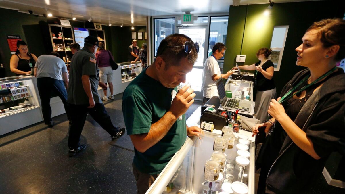 Customers shop for marijuana at a store in Denver.
