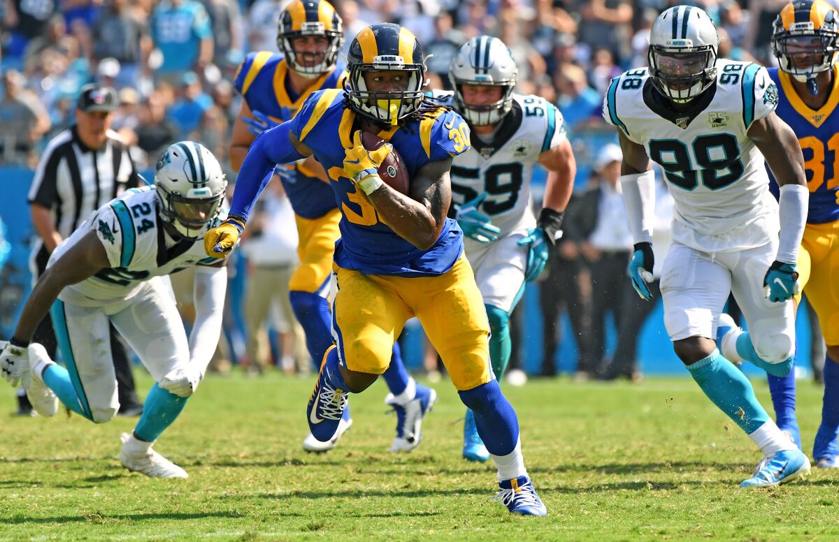 Rams running back Todd Gurley breaks away from the Panthers defense.