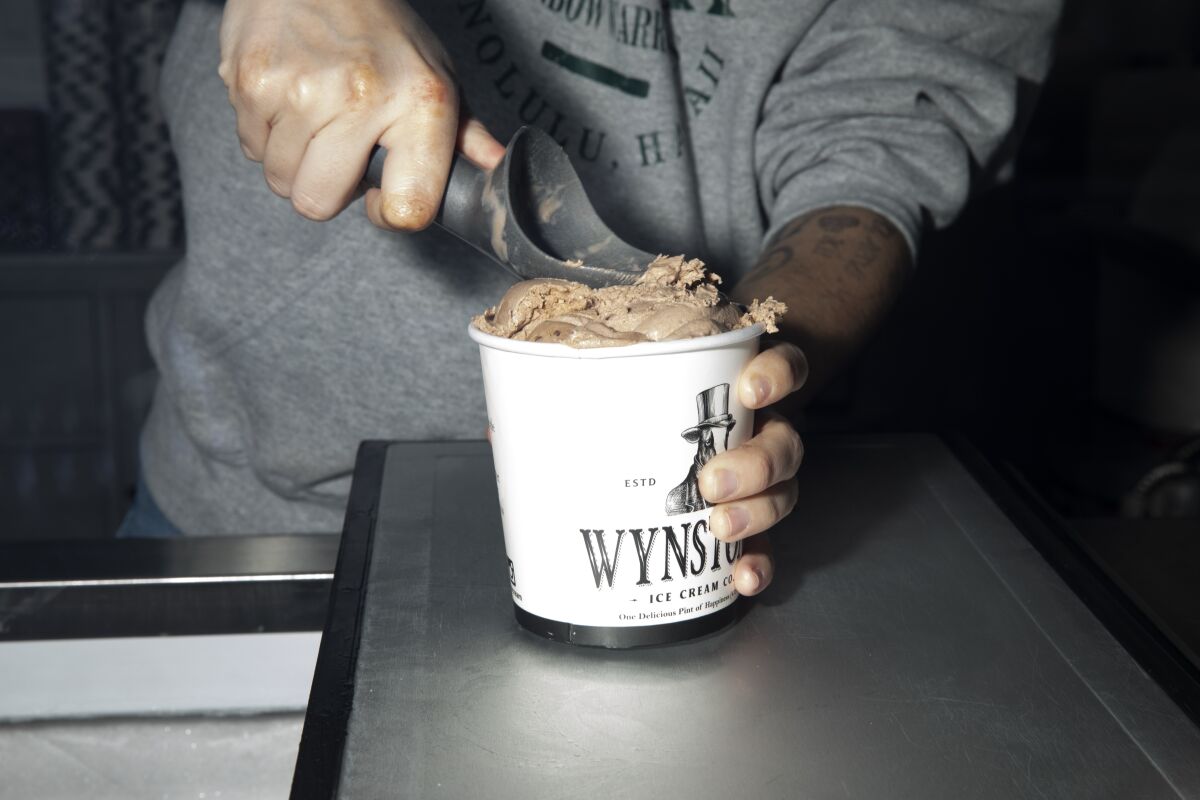 Ella Wynn, 17, packs a pint of chocolate ice cream at Wynston's Ice Cream Co. on Tuesday in San Marcos.